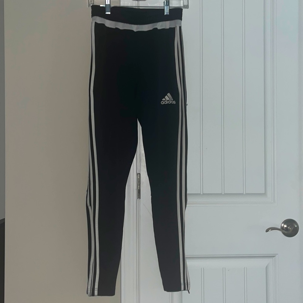 Women’s adidas soccer pants with zipper pockets and zipper at the ankles